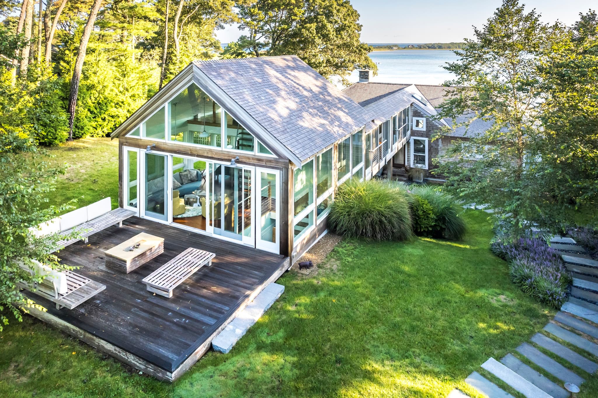 Lake house and intimate deck with a guest house attached to the main home with a skywalk